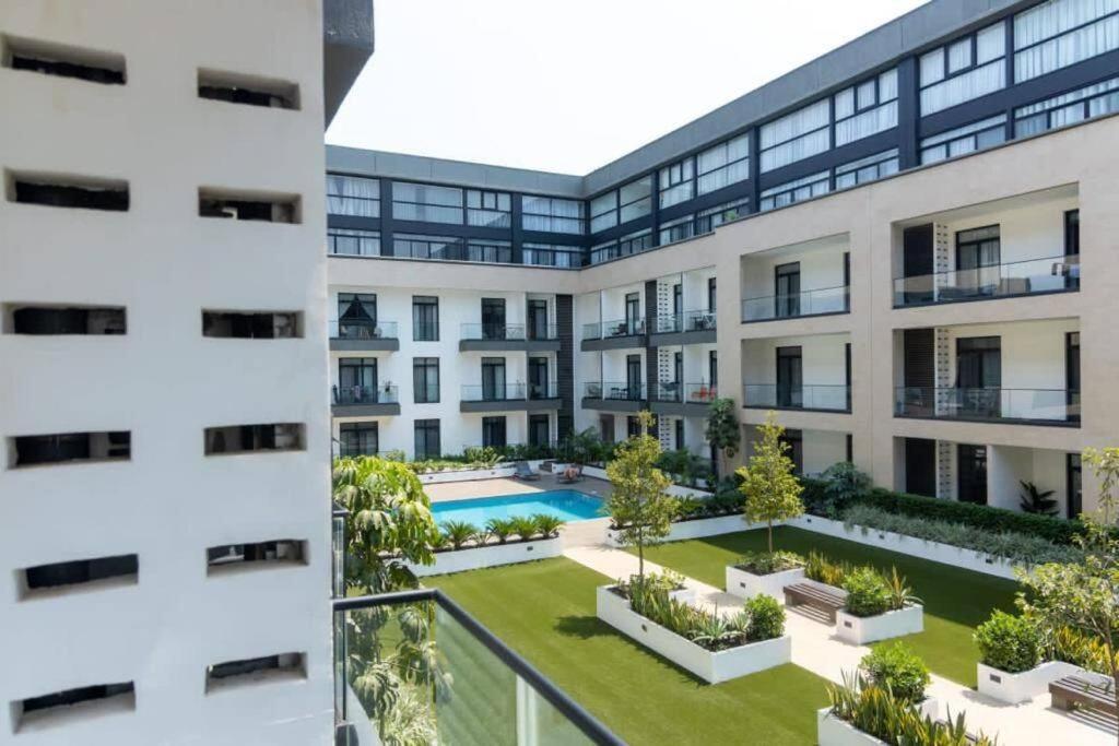 an apartment building with a courtyard and a swimming pool at Blue Sky 2 Bed At Cantonments in Cantonments
