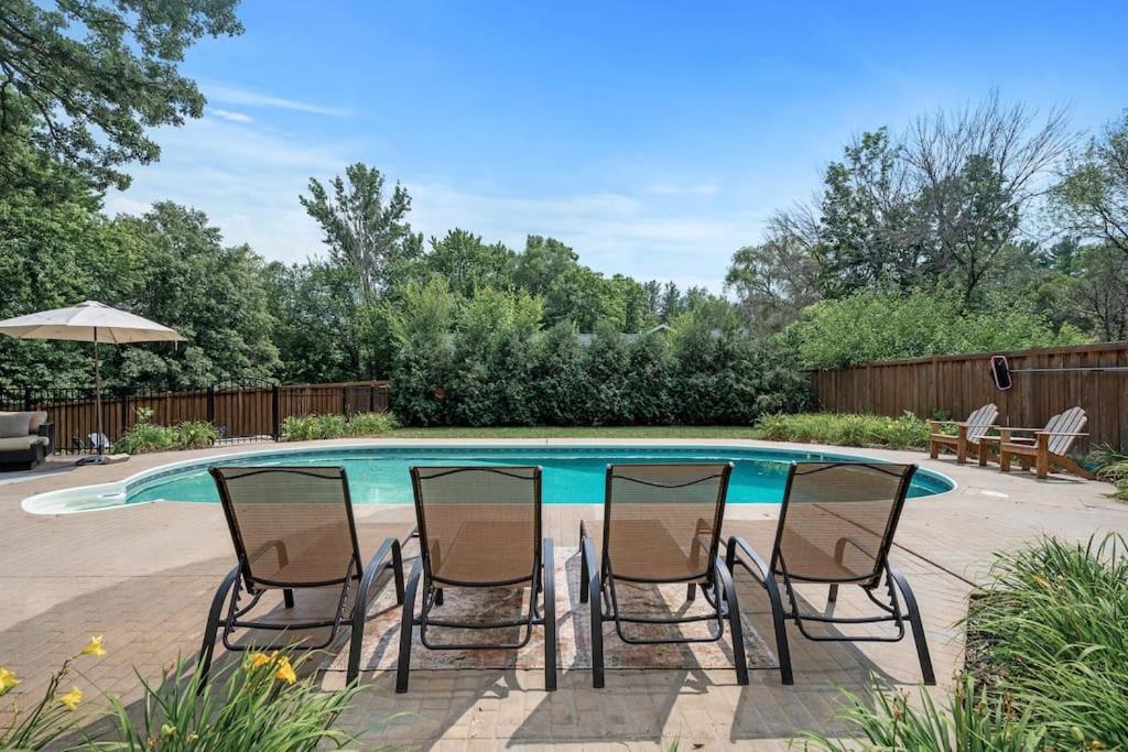un grupo de sillas sentadas alrededor de una mesa junto a una piscina en Large 6-Bedroom w Pool - Private Chef, 