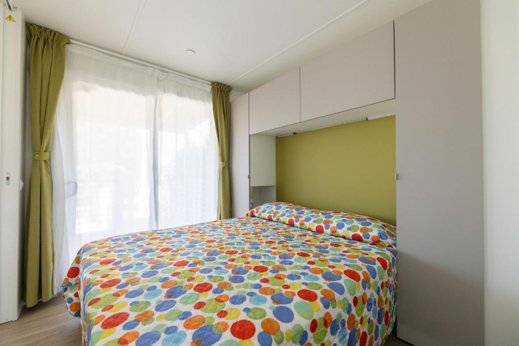 Postel nebo postele na pokoji v ubytování Mobile home Margherita Agricamping Spineta