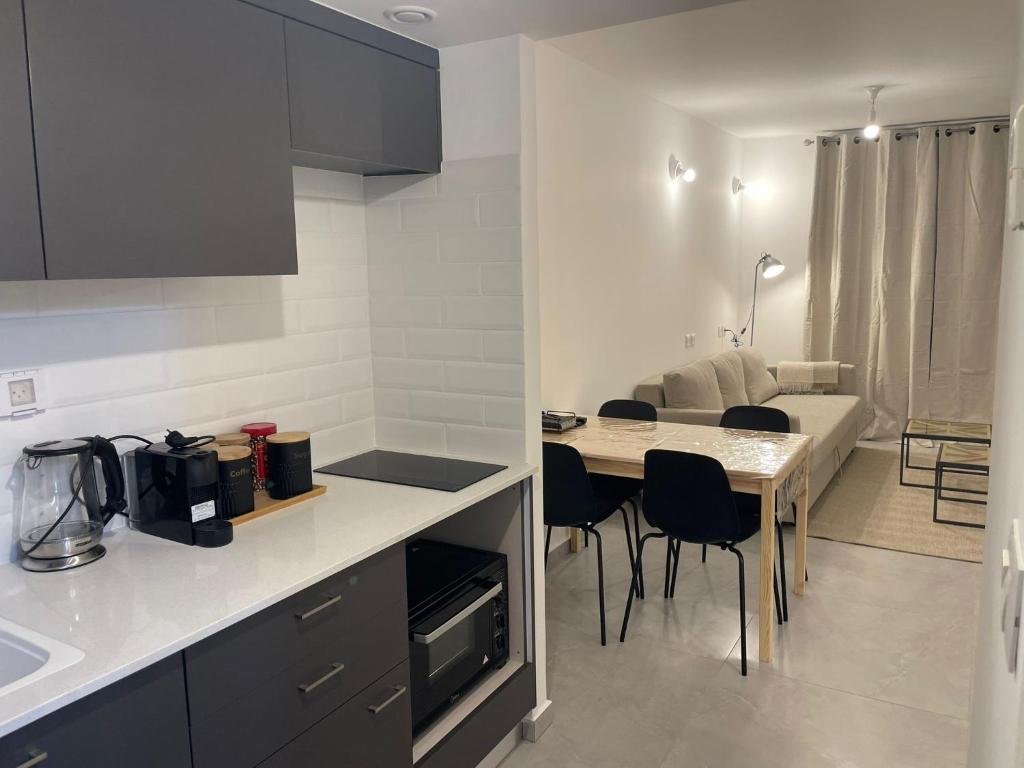 a kitchen and dining room with a table and chairs at oR-Ya Suite in Eilat