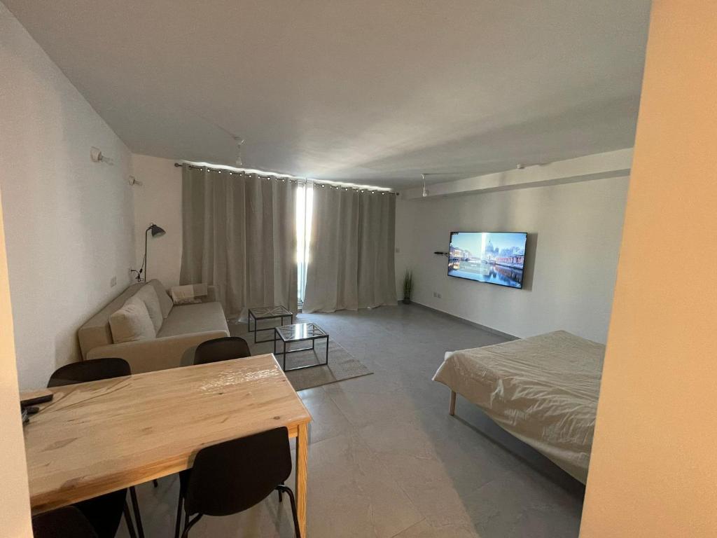 a living room with a bed and a couch at oR-Ya Suite in Eilat