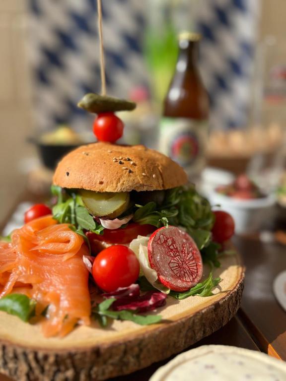a sandwich with tomatoes and vegetables on a table at The White Knight Premium Boutique Hotel in Għajnsielem