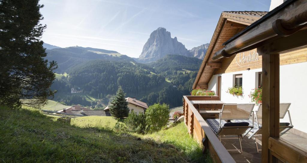a balcony of a house with a view of mountains at Apartments Rondula Pic in Santa Cristina in Val Gardena