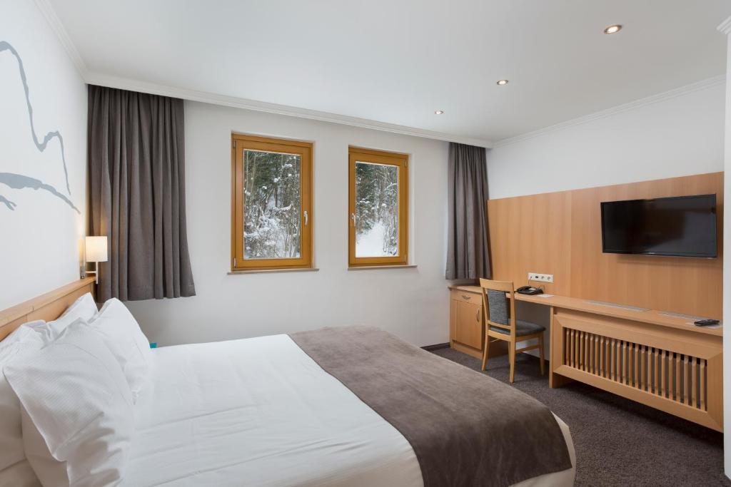 Letto o letti in una camera di Alpine Club Resort