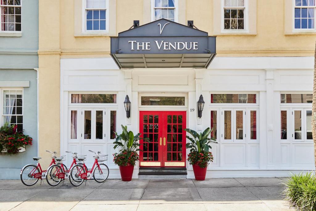 a group of bikes parked in front of a red door at The Vendue, Downtown Art Hotel in Charleston