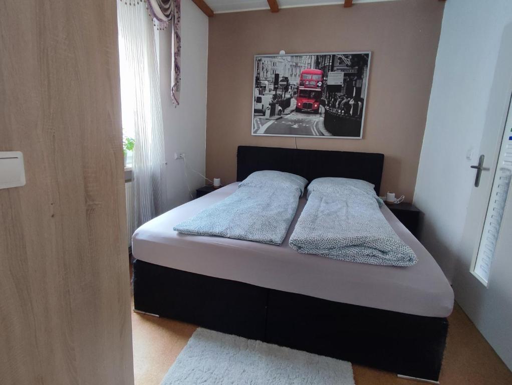 a bedroom with a bed with a red truck in the background at Gästehaus im Alten Fährhaus in Cochem