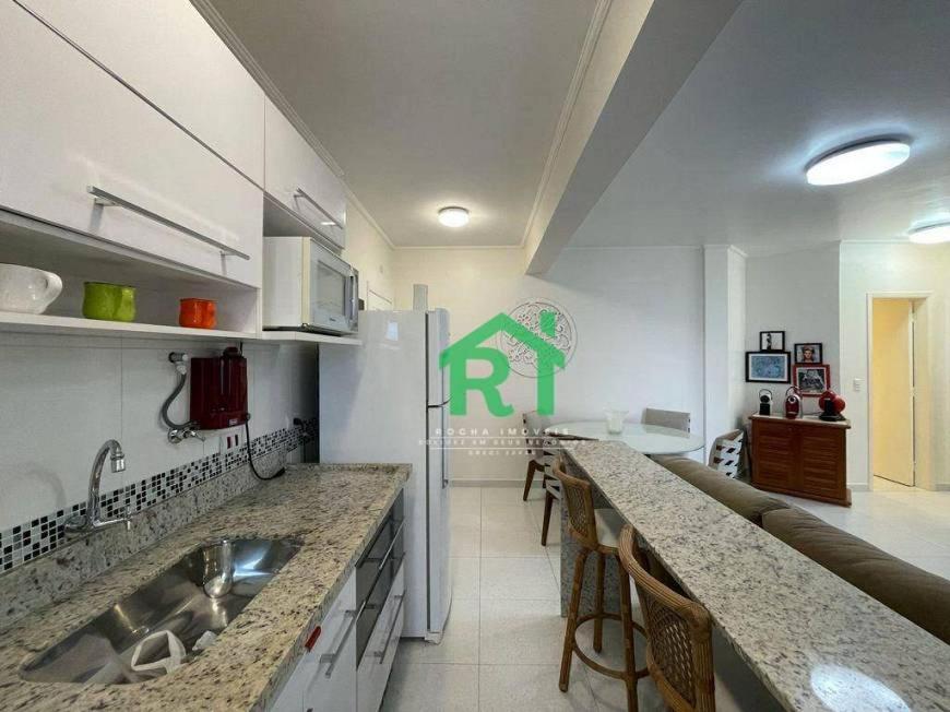 a kitchen with a sink and a counter top at Apartamento dois dormitórios Praia das Pitangueiras in Guarujá