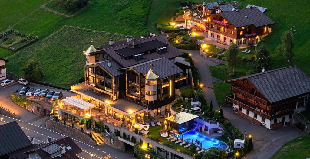 an aerial view of a large house with lights at Alpin Garden Luxury Maison & SPA - Adults Only in Ortisei