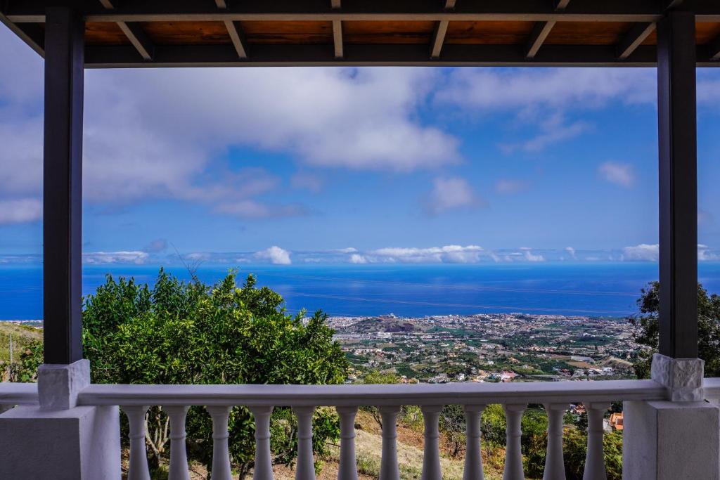 a view of the ocean from a house balcony at Eco House in Unique Environment in La Orotava