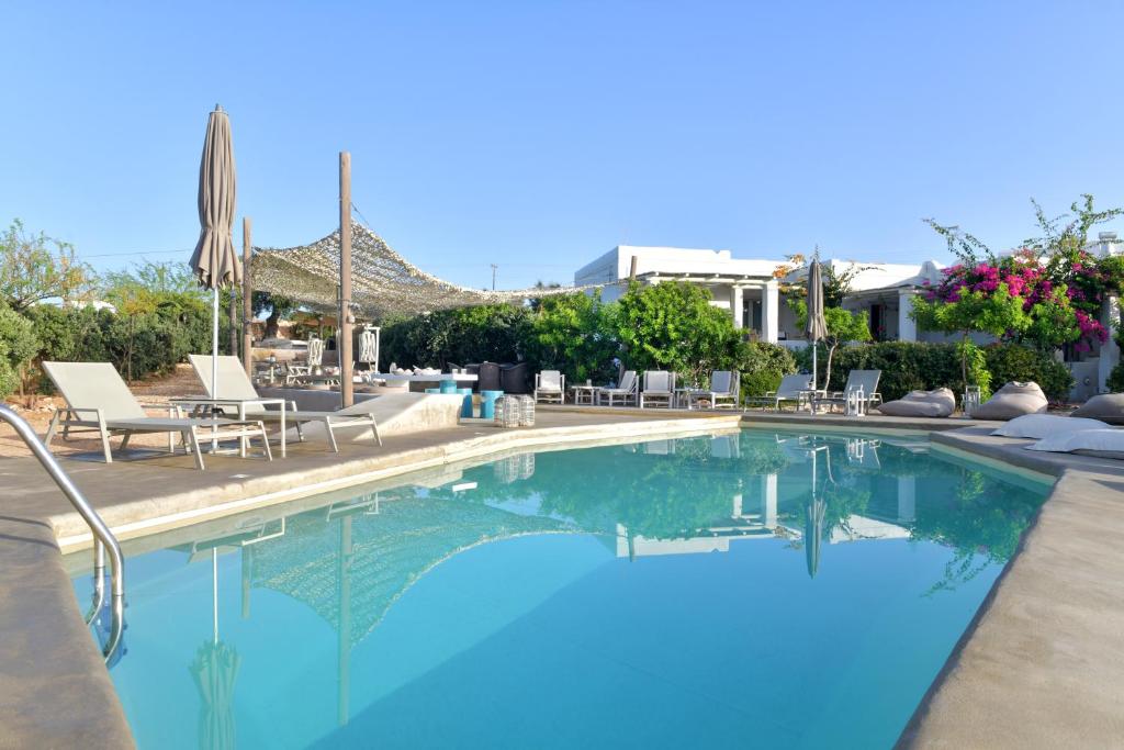 a swimming pool with blue water in a resort at Portes Houses in Koufonisia