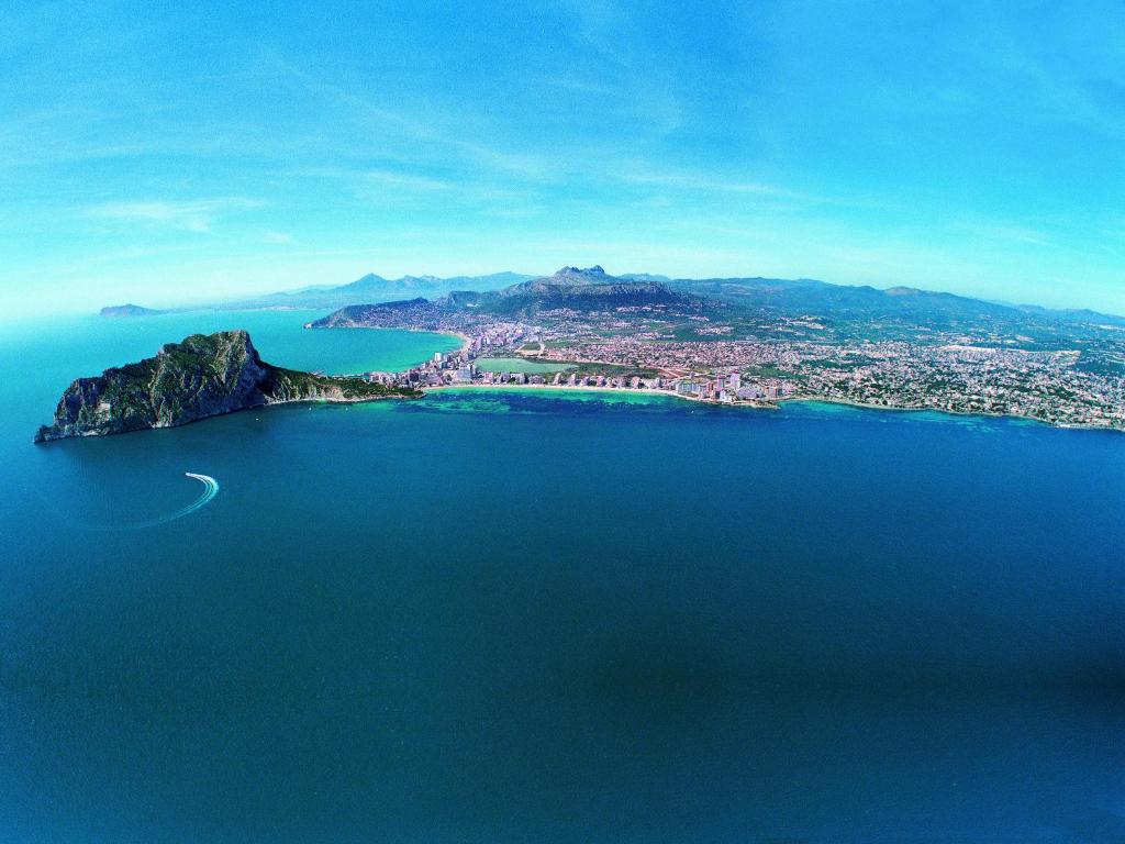 an island in the middle of a large body of water at AR Roca Esmeralda & SPA Hotel in Calpe