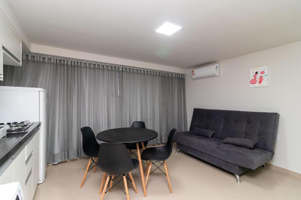 a living room with a couch and a table and chairs at Asa Norte, Brasília - NOR in Brasilia