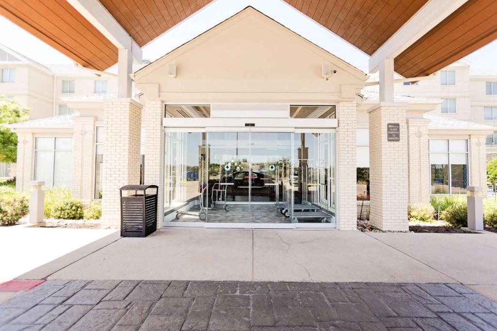 a large glass door in a building with a patio at Hilton Garden Inn Temple Medical Center in Temple
