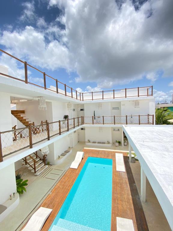 a large balcony with a swimming pool on top of a building at Monte Alegre Beach in São Miguel do Gostoso