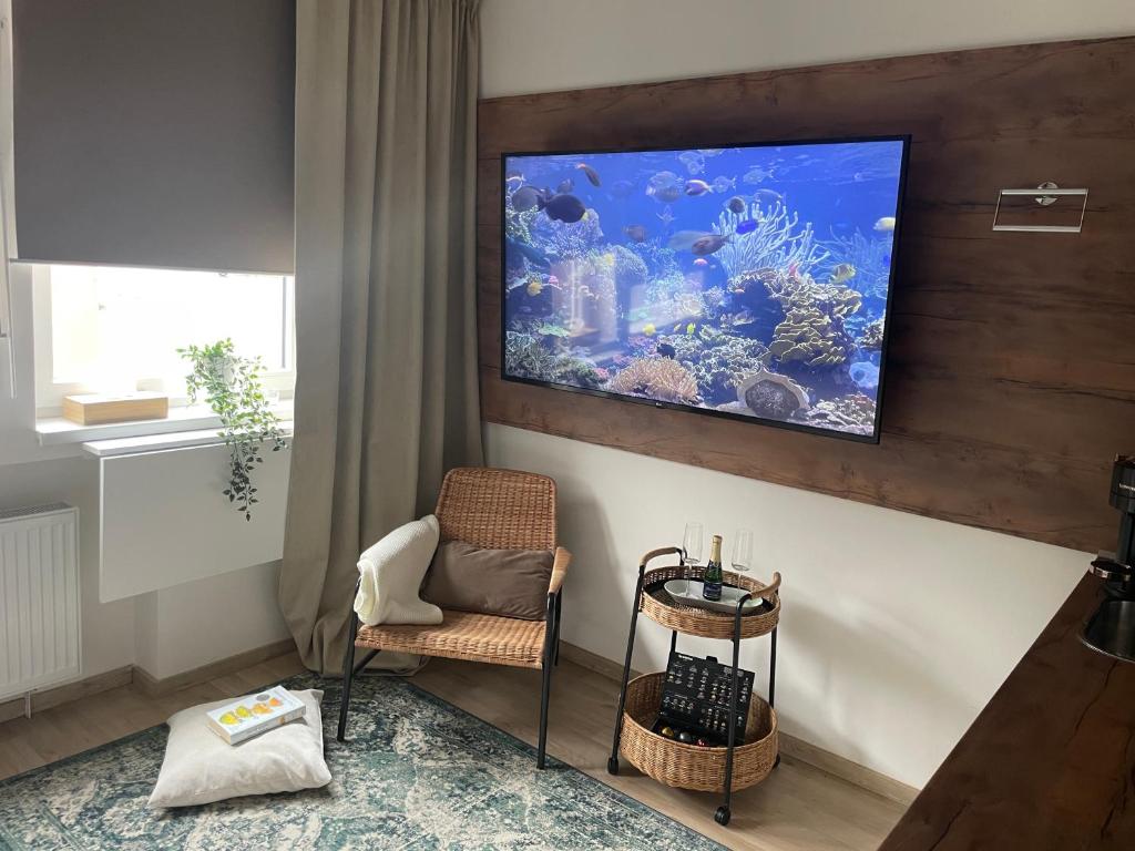 a living room with a large aquarium on the wall at DE LUXE Apartment, WIFI, TV 65" in Prague