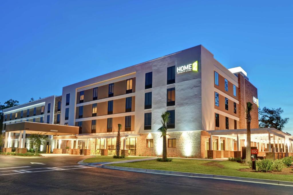 an exterior view of the hotel at night at Home2 Suites By Hilton Beaufort in Beaufort