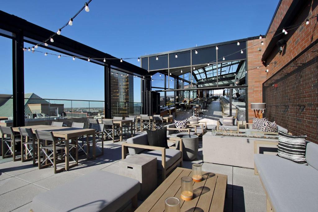 a patio with tables and chairs on a building at Canopy By Hilton Columbus Downtown Short North in Columbus