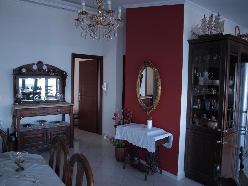 a dining room with a table and a mirror at NINEMIA in Amfilochía