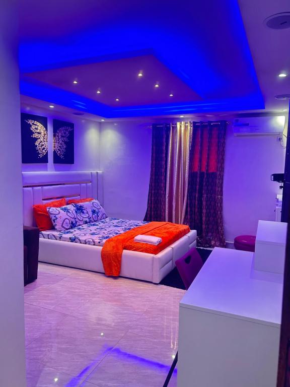 um quarto com uma cama com um tecto azul em Paryssonalo em Dakar