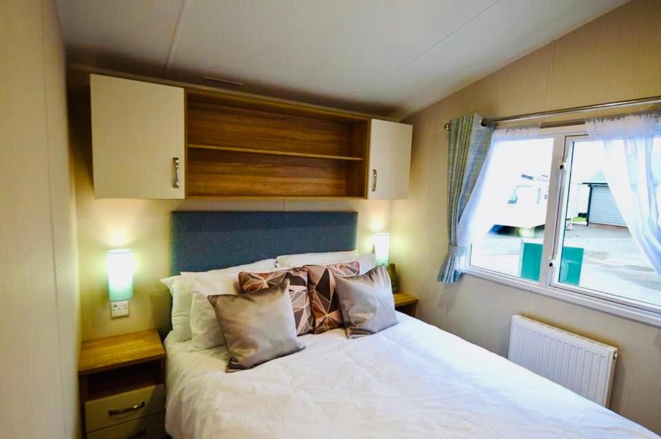 a bedroom with a large white bed with a window at 3 bedroom Heaven Home in Chichester