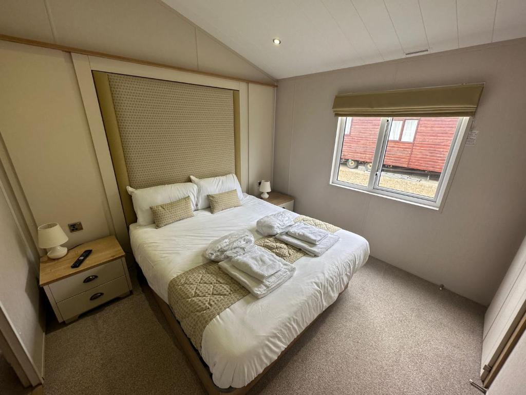 a small bedroom with a bed and a window at Heaven Home in Chichester