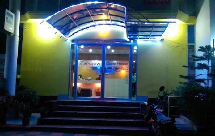 a building with stairs in front of a store at Rainbow Guest House in Sylhet