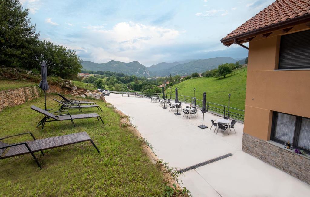 a group of benches sitting on a sidewalk next to a building at Apartamentos Spa Las Caldas y Spa El Balneario in Oviedo