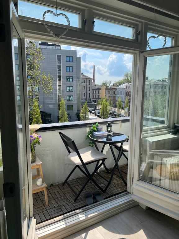 a balcony with a table and a view of a city at Central Comfort Room in heart of Oslo, Majorstuen in Oslo