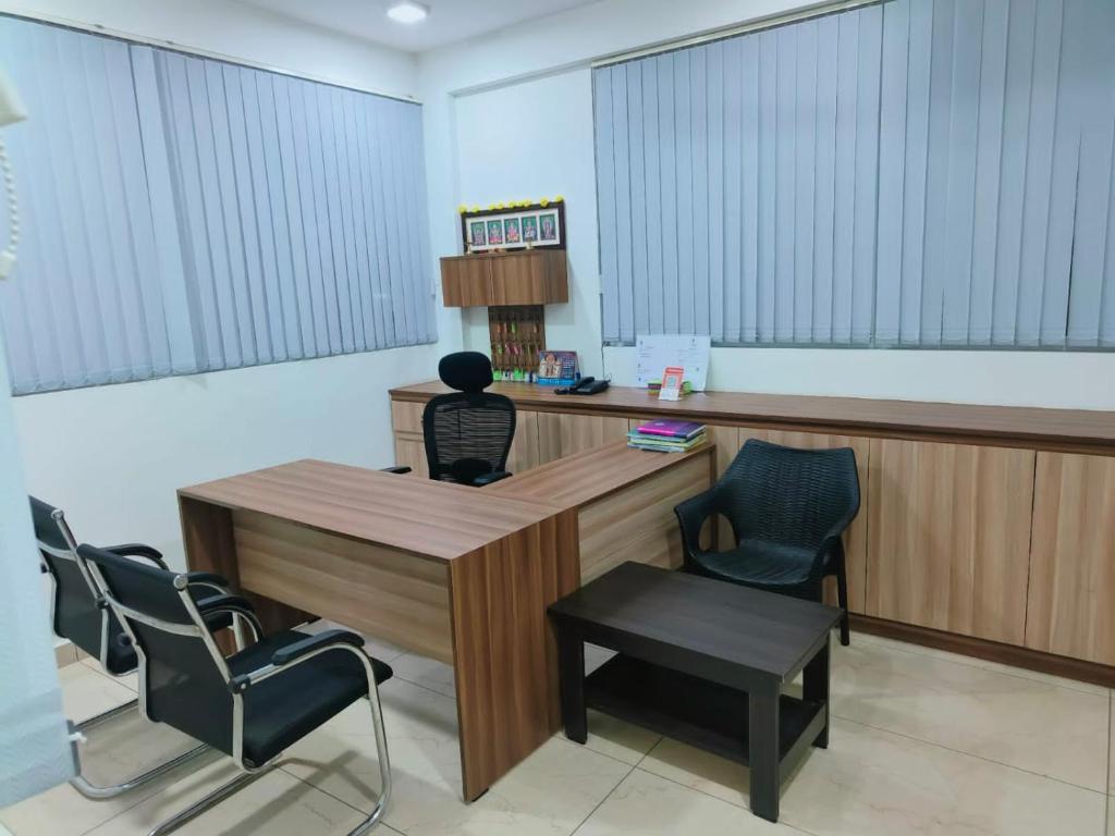a waiting room with chairs and a desk at Alohaa Homestel in Coimbatore