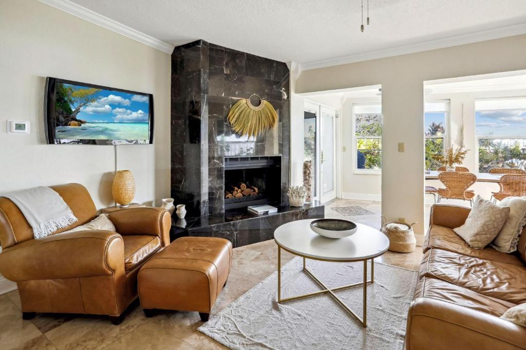 a living room with two couches and a fireplace at Coconut Paradise in St Pete Beach