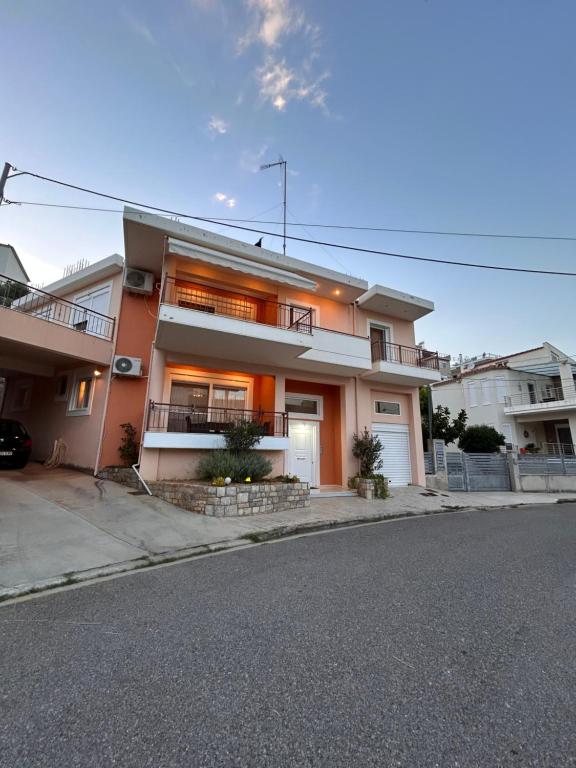 a house on a street with a driveway at Feel at home - Kalamata - Near the center in Kalamata