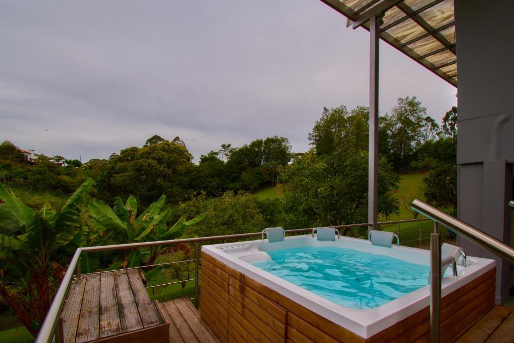 a jacuzzi tub on the deck of a house at HOTEL KOKUMI in Rionegro