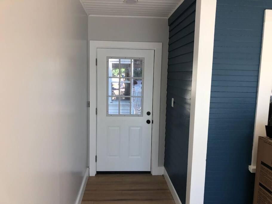 a hallway with a white door and a window at Canobie Lake 3bedroom waterfront in Windham