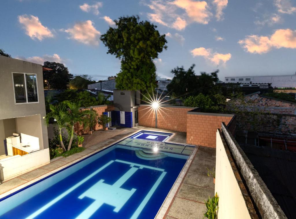a swimming pool on the roof of a house at Hotel Montanar HOME in La Dorada