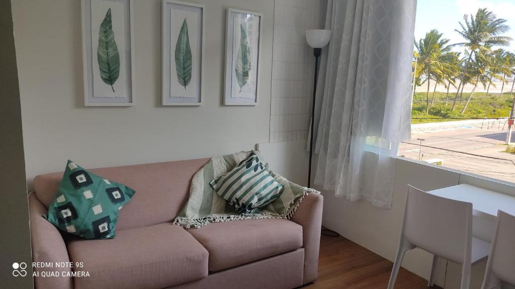a living room with a couch and a table and a window at Estilo Bela Vista 308 in Cabedelo