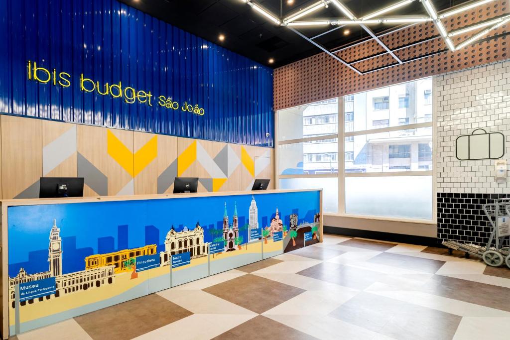 un vestíbulo de un edificio con un mural de lugares de interés en ibis budget SP Centro Sao Joao en São Paulo
