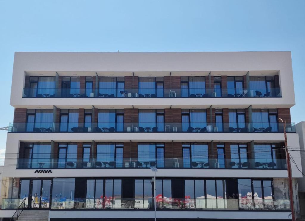 an apartment building with a lot of windows at Hotel Nava in Eforie Nord