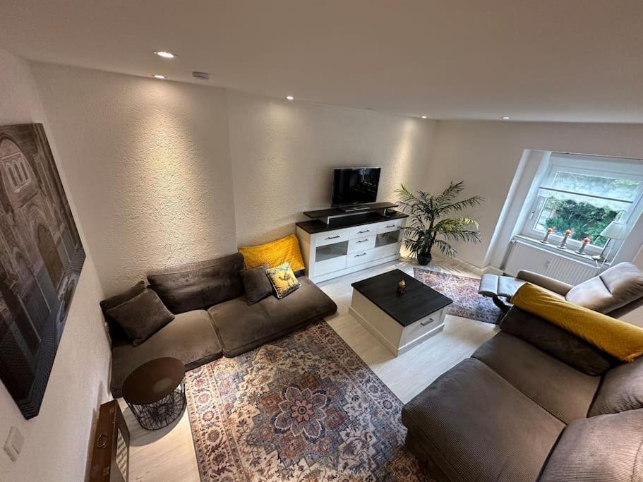 a living room with a couch and a tv at Orient Apartment nähe Autobahn A57 in Krefeld