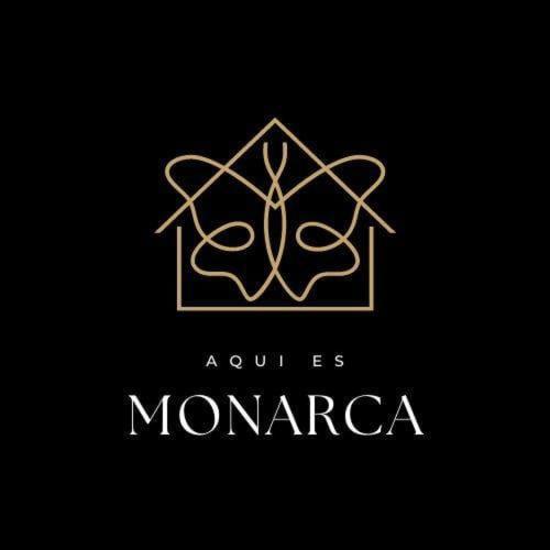 a logo for a company with a monogram at Hostal MONARCA in Jamundí