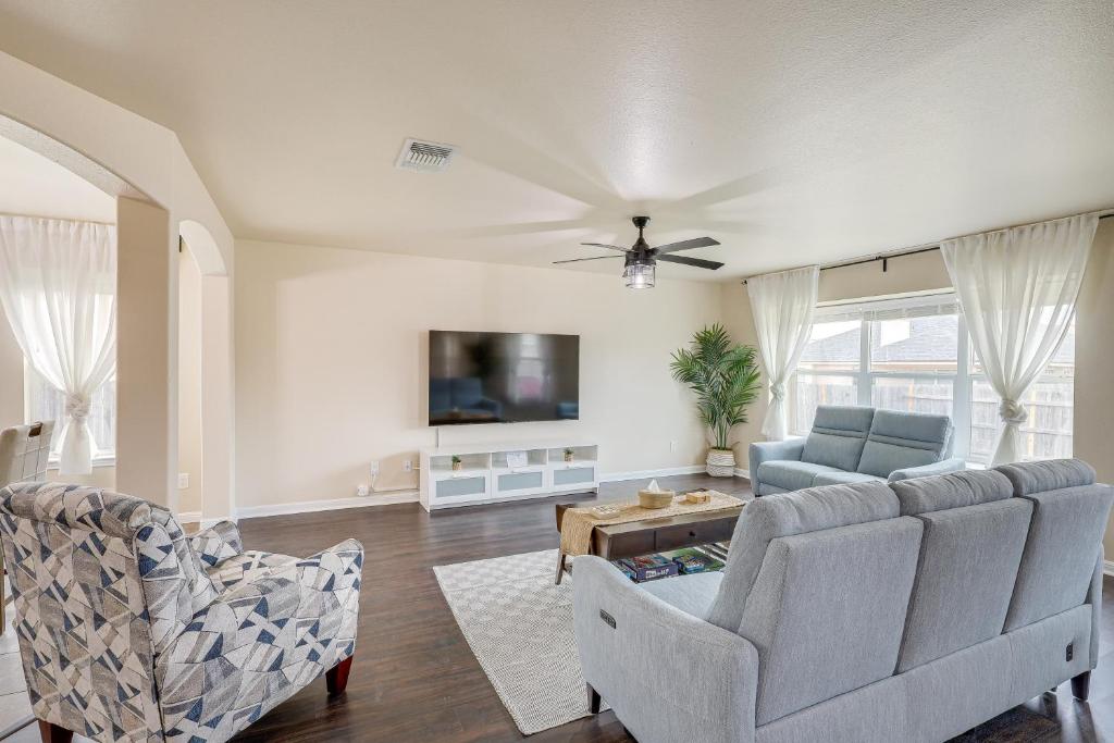 a living room with a couch and a tv at Modern Killeen Vacation Rental with Private Patio! in Killeen