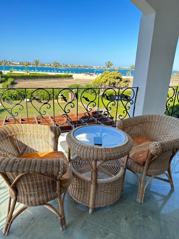 a patio with chairs and a table on a balcony at فيلا مارينا 4 الساحل الشمالي in El Alamein