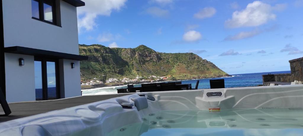 a bath tub with a view of the ocean at Casa da Ponta Negra in Vila do Porto