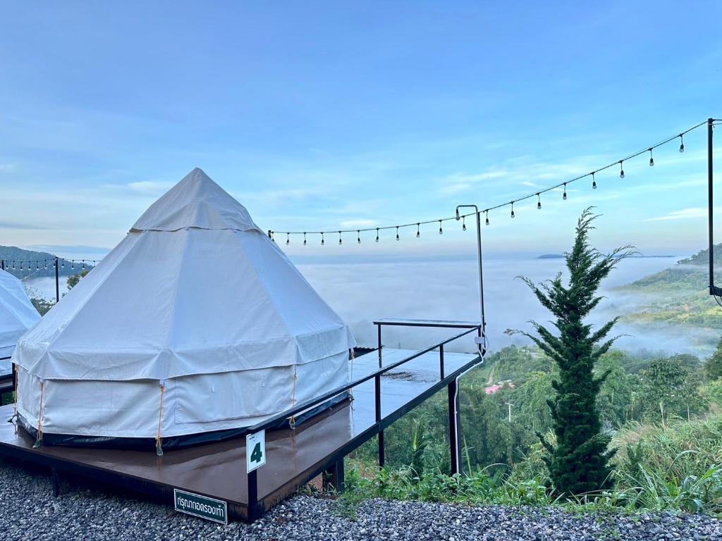 a yurt on a platform with a view of the water at Peace Zone เขาค้อ in Khao Kho