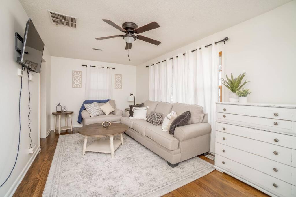 a living room with a couch and a ceiling fan at 2 Bed 1 Bath Home w 2 Car Garage & Fenced Yard in Wichita