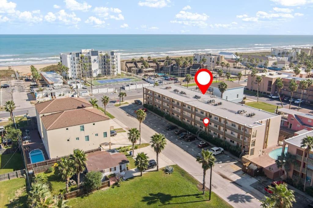 an aerial view of a city with a building and the ocean at 2 Bed 2 Bath 1st Floor Condo w Pool By Beach in South Padre Island