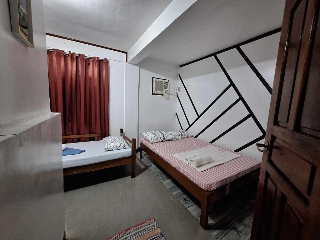 Postel nebo postele na pokoji v ubytování Blessed Inn Annex