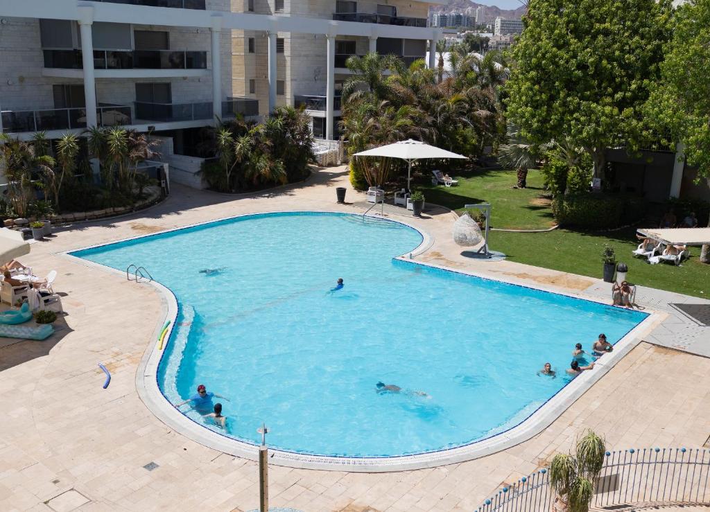 Elle offre une vue sur la grande piscine. dans l'établissement FishaRent Luxury Royal Park Suites, à Eilat
