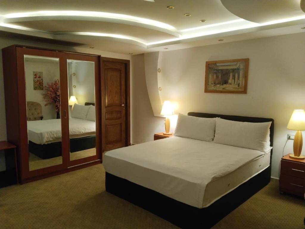 a hotel room with a bed and a mirror at باب المدائن in Cairo