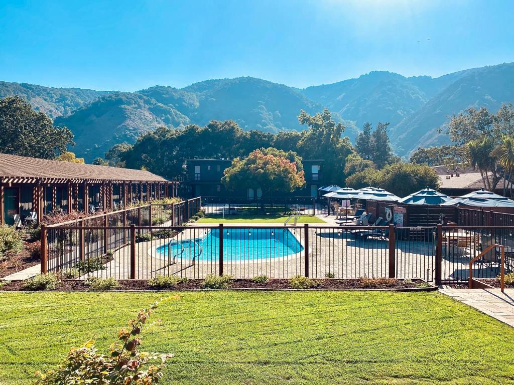 a resort with a pool and mountains in the background at Hidden Valley Inn in Carmel Valley