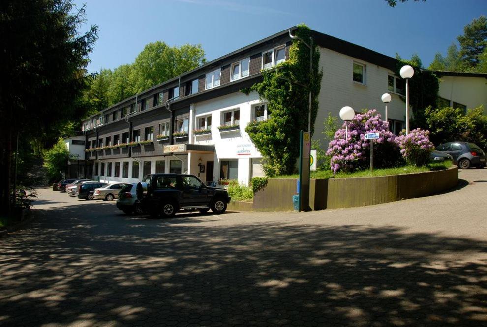 a black car parked in front of a building at Hotel Eifeltor in Mechernich